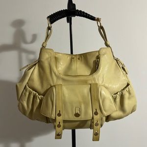 YSL vintage horn handle bag in a butter yellow leather with gold hardware.